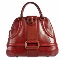 ALEXANDER MCQUEEN; a red leather Novak handbag, circa 2006, with brass metal hardware and front