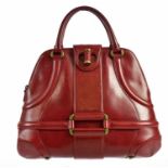 ALEXANDER MCQUEEN; a red leather Novak handbag, circa 2006, with brass metal hardware and front