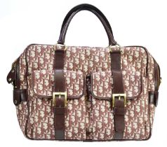 CHRISTIAN DIOR; a monogram cloth and leather burgundy weekend bag, with two front pockets, top