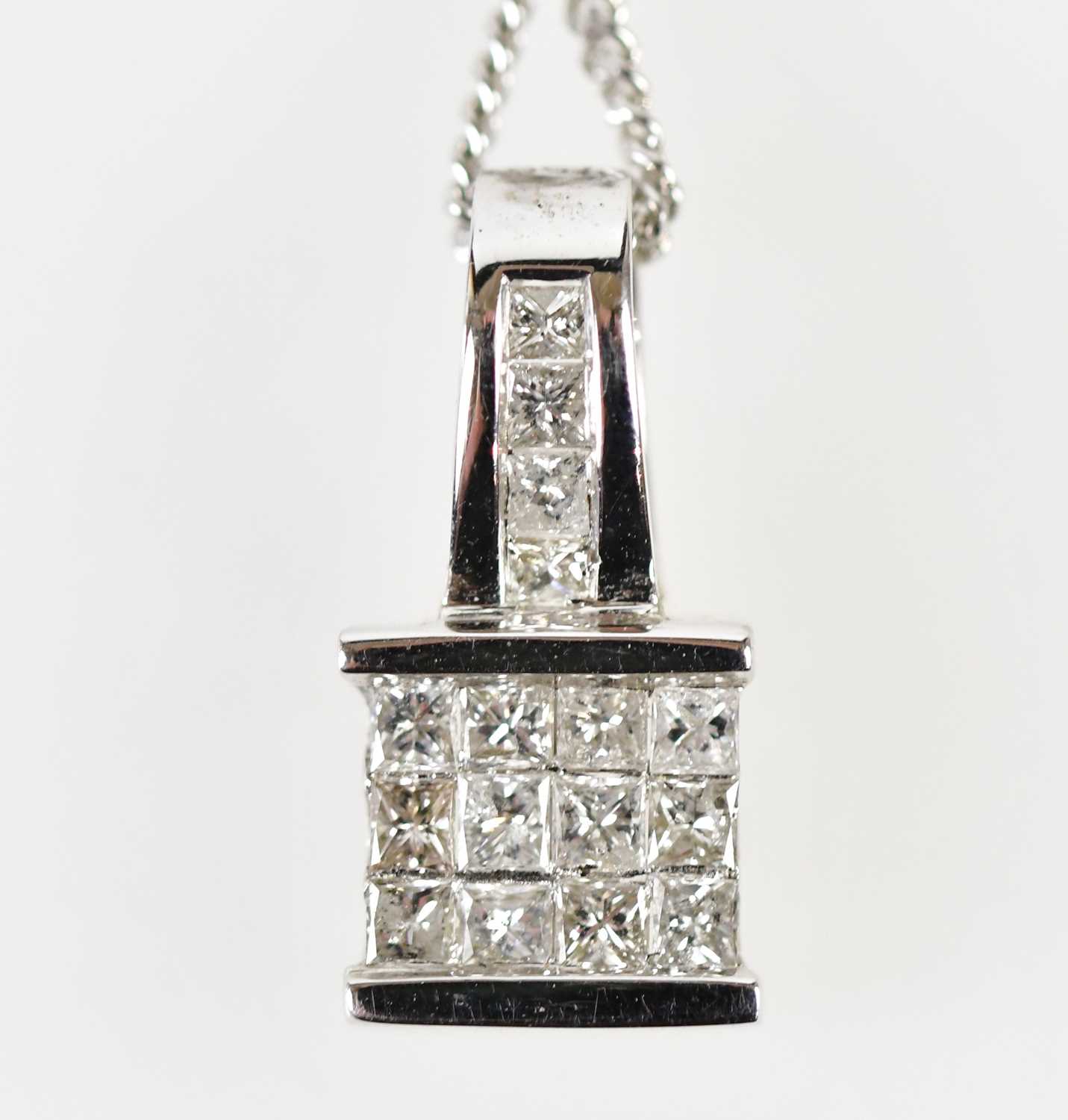 An 18ct white gold and diamond set pendant with four diamonds to the bail and twelve diamonds to the