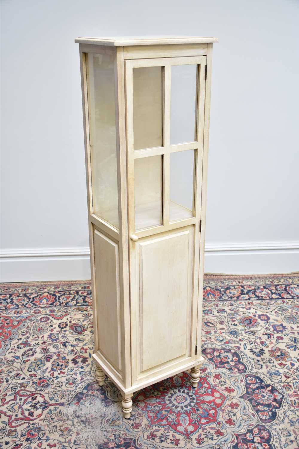 A modern white painted display cabinet with single glazed and panelled door, width 41cm, depth 30cm,