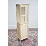 A modern white painted display cabinet with single glazed and panelled door, width 41cm, depth 30cm,