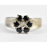 An 18ct yellow gold flower head ring set with sapphires and tiny central diamond, size G, approx 3.