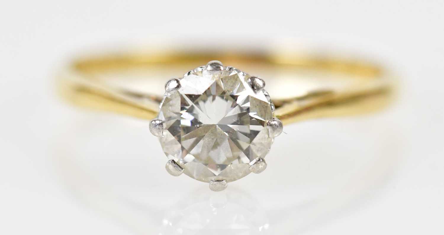 An 18ct yellow gold platinum tipped diamond solitaire ring, the round brilliant cut eight claw set