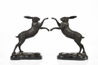 AFTER PIERRE-JULES MENE; a pair of modern bronze model of hares, on shaped marble bases, height 29cm