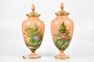 A pair of Victorian painted opaque glass lidded jars with floral decoration, height 42cm, bearing