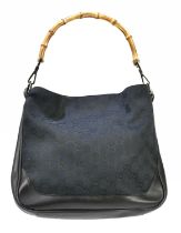 GUCCI; a black monogram canvas GG handbag with bamboo handle and black leather trim, with canvas