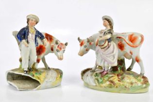 A pair of 19th century Staffordshire figures, representing a boy and girl beside cattle (af)