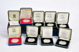 A collection of twenty cased silver proof coins including Elizabeth II Silver Jubilee examples.