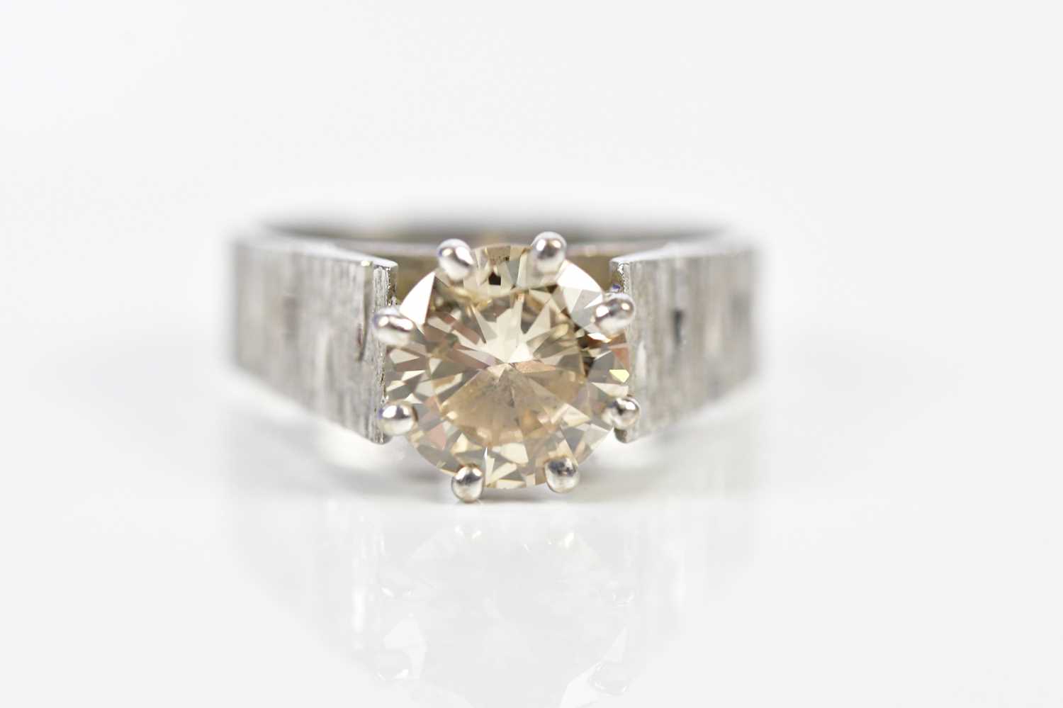 A white metal diamond solitaire ring, the claw set round brilliant cut stone approx 2cts, with