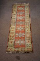 A hand woven wool runner, worked with a striped Paisley design, 340 x 89cm.