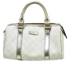 GUCCI; a cream coated canvas GG monogram bowling bag, trimmed with gold leather and gold tone