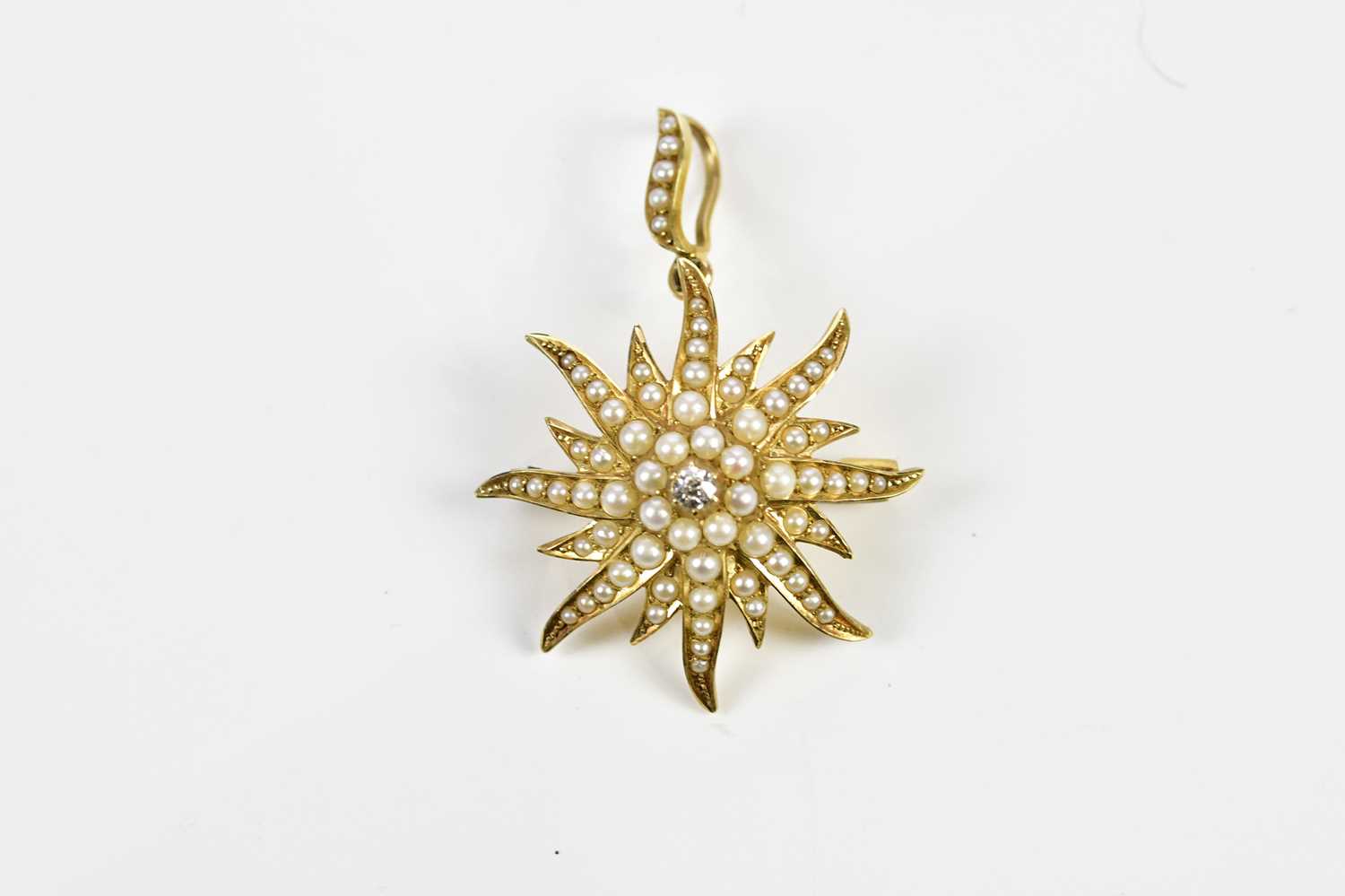 A late Victorian 15ct yellow gold seed pearl and diamond set sunburst pendant/brooch, length