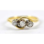 An 18ct yellow gold and platinum three stone diamond dress ring, size K 1/2, approximate weight 2.