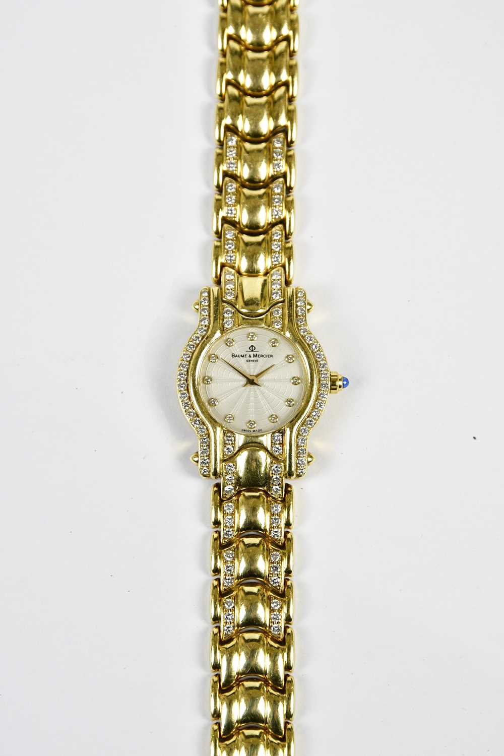 BAUME & MERCIER; a lady's 18ct gold and diamond set wristwatch, the engine turned dial set with