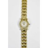 BAUME & MERCIER; a lady's 18ct gold and diamond set wristwatch, the engine turned dial set with