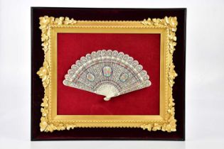 A Victorian hand painted bone fan, with pierced and floral decoration, in gilt and ebonised frame,