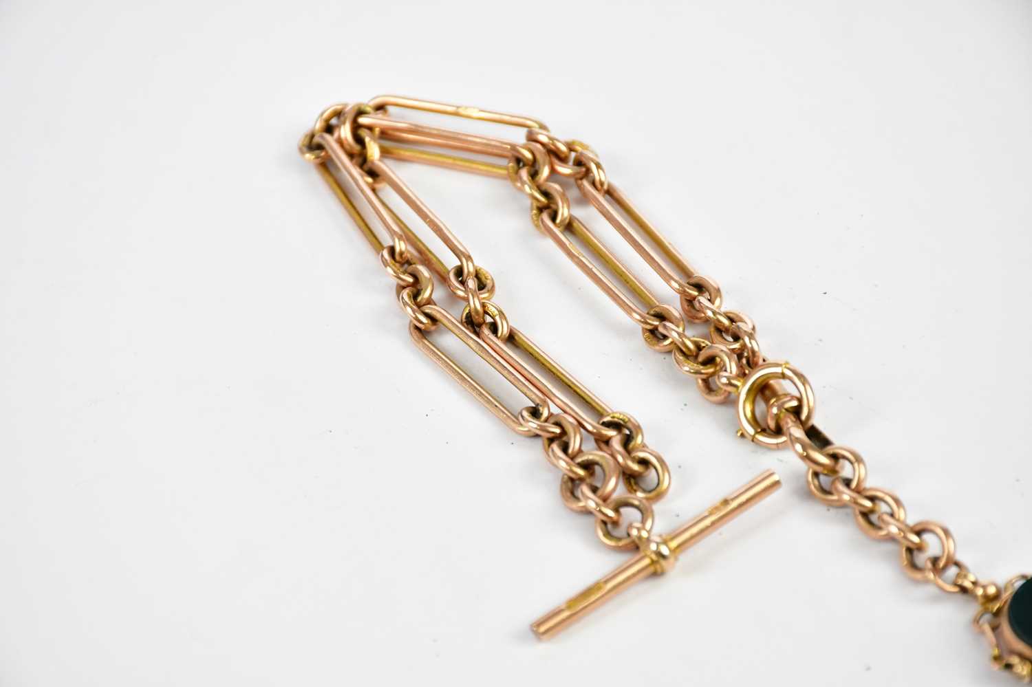 A 9ct yellow gold trombone link chain with bloodstone set swivel fob and T-bar, length 39cm, - Image 2 of 2