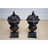 A large pair of bronze urns with floral decoration to the tops, height 75cm.