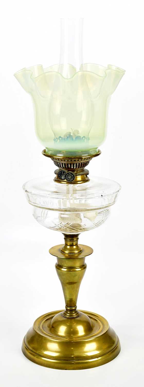 A Victorian brass oil lamp, with vaseline glass shade and Palmer & Co duplex wick holder above the