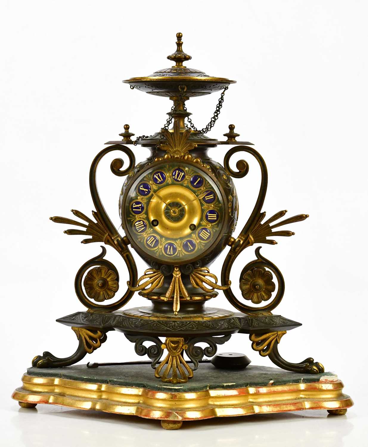 An aesthetic movement French bronze and gilt metal mantel clock with circular finial above the