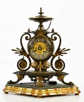 An aesthetic movement French bronze and gilt metal mantel clock with circular finial above the