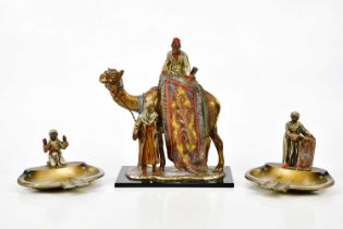 AFTER FRANZ BERGMANN; an Austrian cold painted spelter match striker modelled as a carpet seller