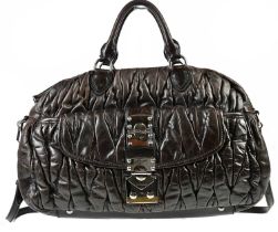 MIU MIU; a brown leather Barletto bowler bag, with silver tone hardware buckle to front, maker's