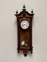 A 19th century Vienna style wall clock, the white enamel dial set with Roman numerals, height 86cm.