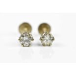 A pair of diamond ear studs, each claw set round brilliant cut stone weighing approx. 0.40cts,