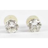 A pair of white metal diamond ear studs, each round brilliant cut stone weighing approx. 0.75cts, in