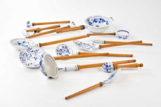 In the manner of Meissen; a collection of blue and white porcelain kitchen utensils with turned