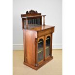 A Victorian mahogany chiffonier of small proportions, the raised back with scrolling detail and