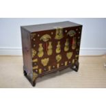 A Chinese brass applied pine and elm tonsu chest on shaped bracket feet, width 102cm, depth 43cm,