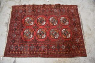 A red ground Bokhara style rug with elephant decoration, 134 x 105cm.