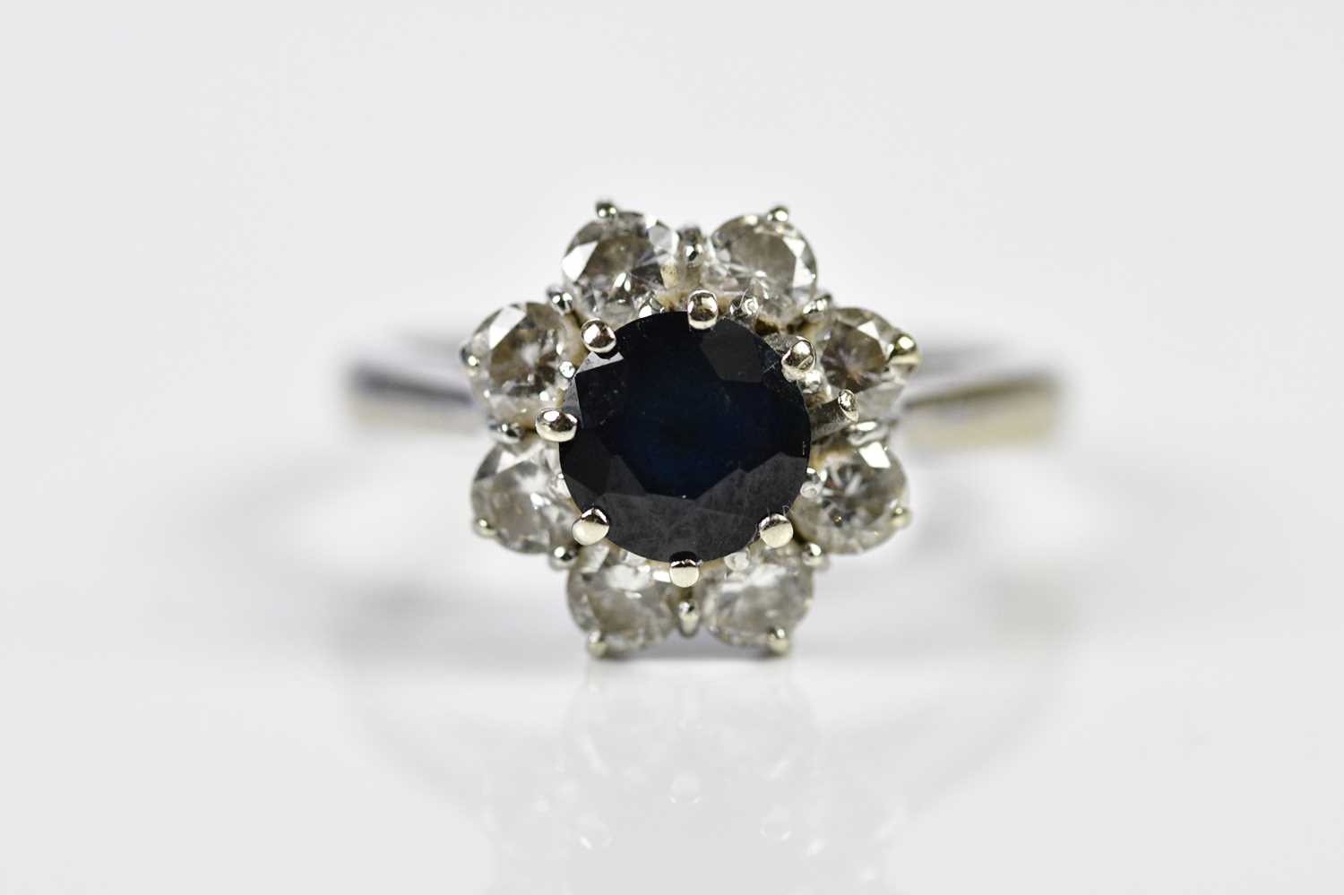 An 18ct white gold sapphire and diamond flowerhead ring, size J, approx. 4.2g. Condition Report: The