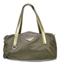 PRADA; a brown nylon and antique gold leather bowling bag with side zip pocket, top handles and