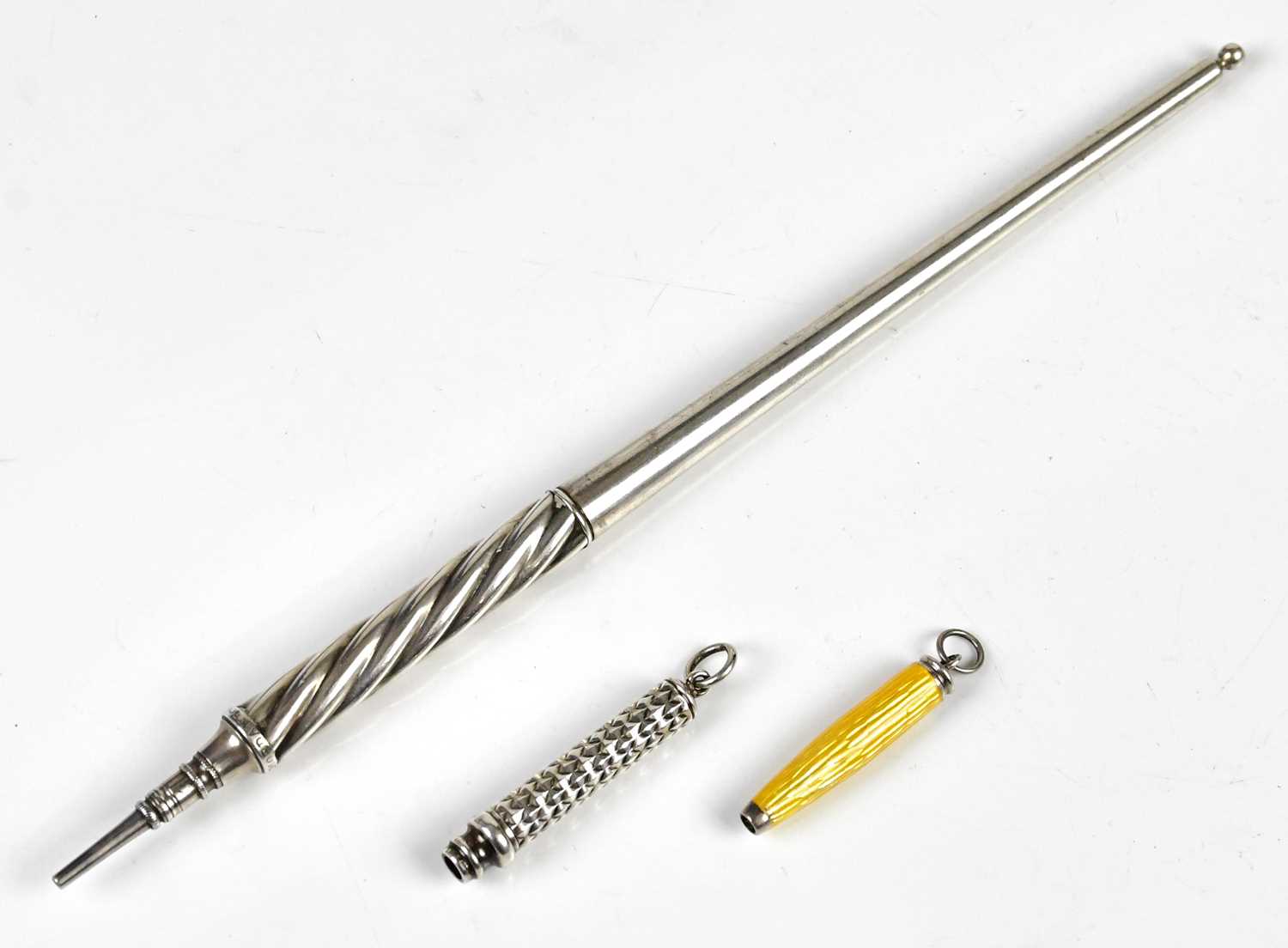 SAMPSON MORDAN; a white metal pencil of tapering form with wrythen grip, length 19cm, a miniature