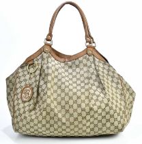 GUCCI; a brown M M canvas Supreme handbag with tan leather trim, large logo bag charm, gold tone