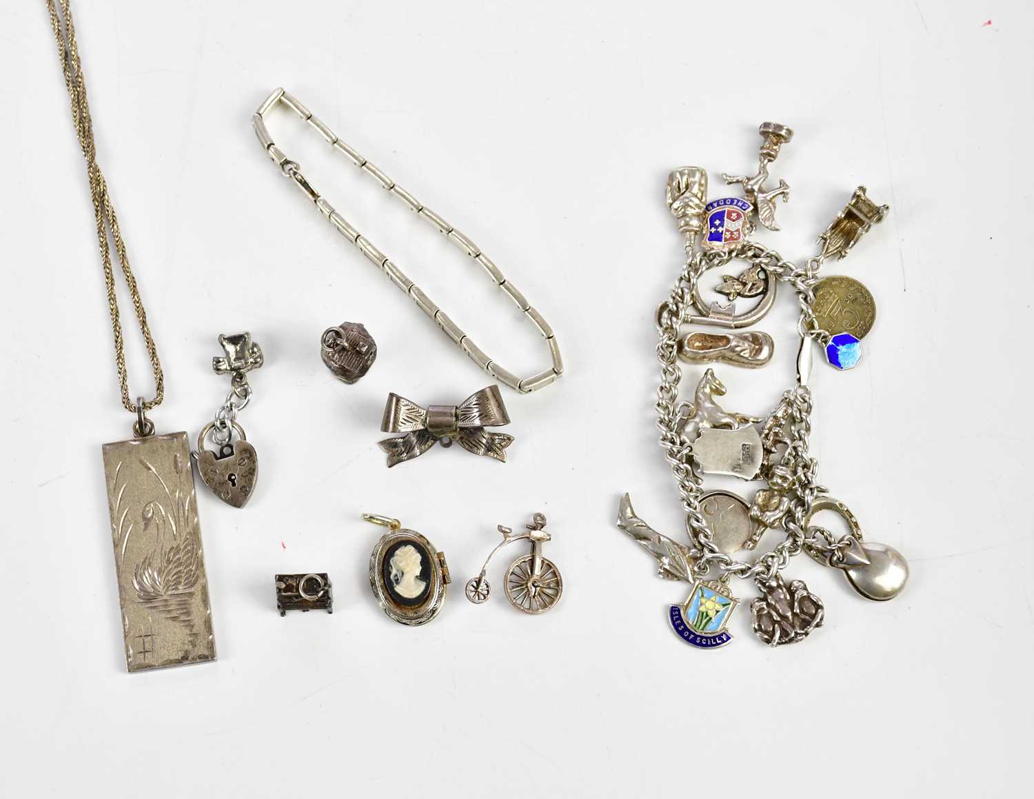 A group of silver and white metal jewellery including a charm bracelet, ingot on chain etc, combined