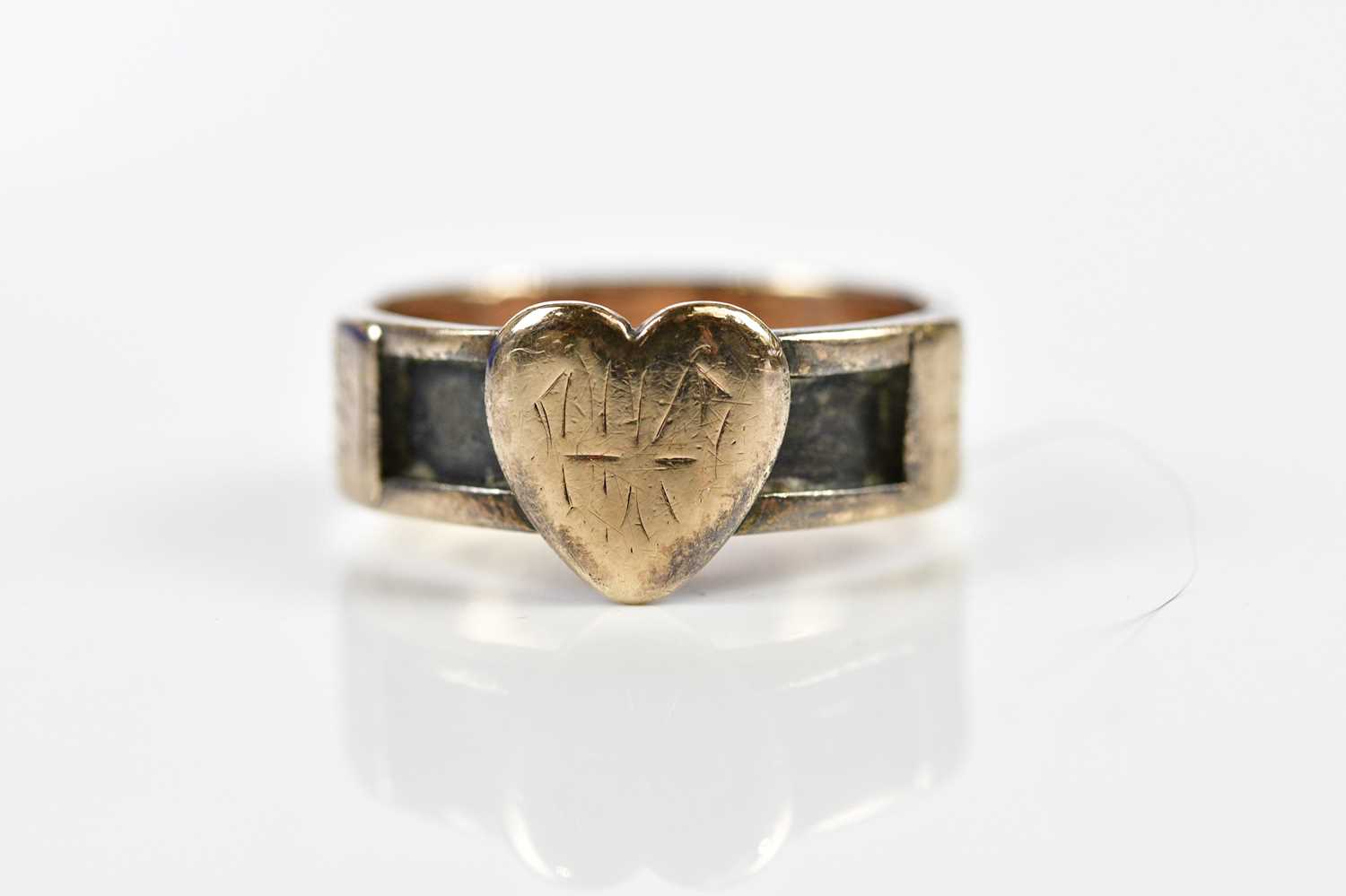 A 9ct yellow gold mourning ring with heart shaped terminal and inset panels originally for hair,