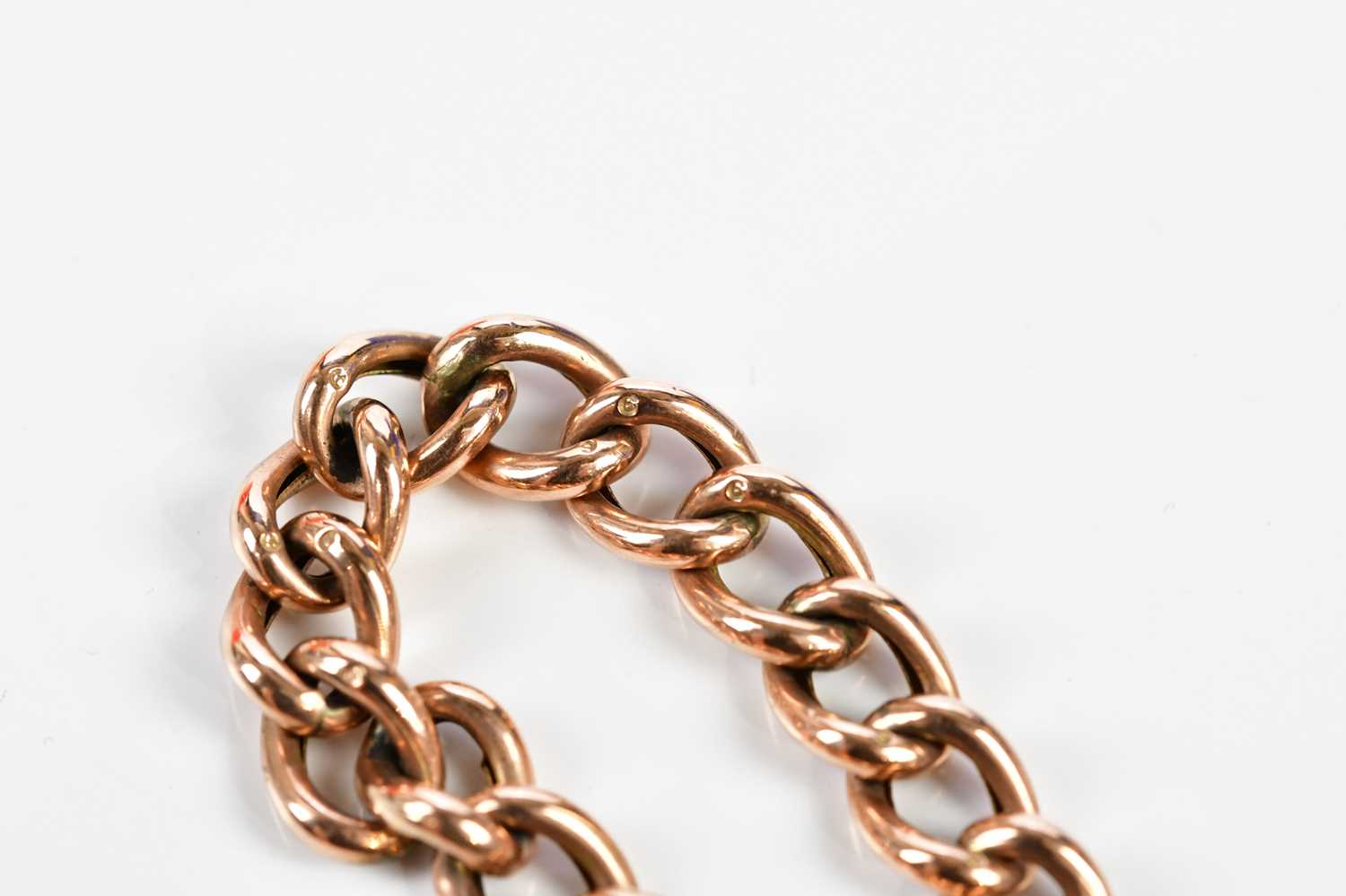 A 9ct rose gold hollow curb link bracelet with padlock and safety chain, approx. 15.85g. - Image 4 of 5