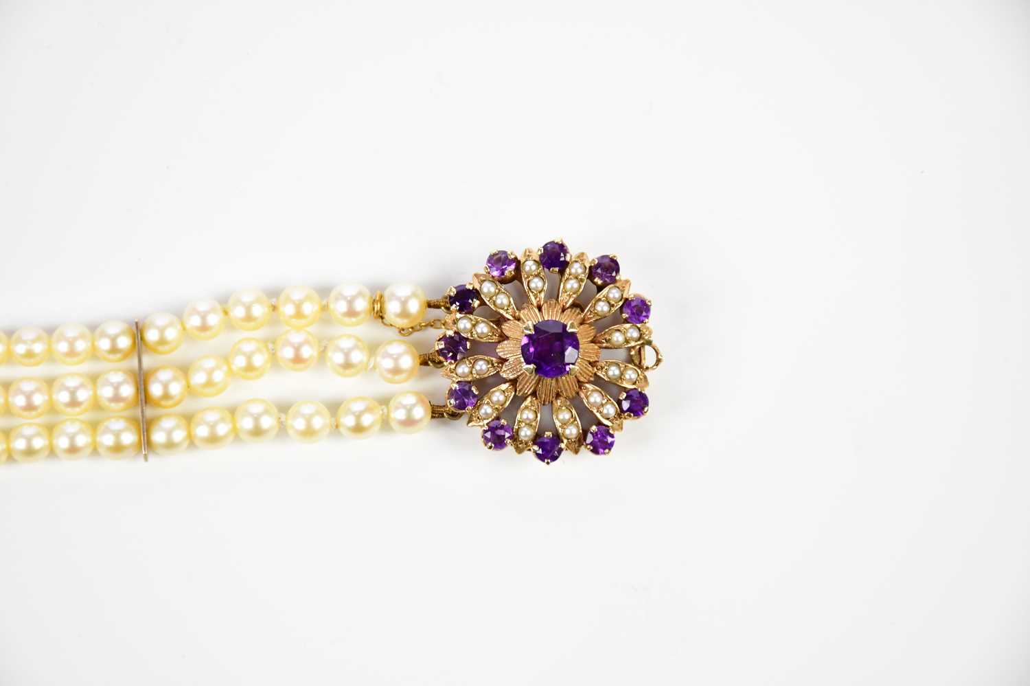 A three strand cultured pearl bracelet with large amethyst and pearl set 9ct gold clasp, length - Image 2 of 3
