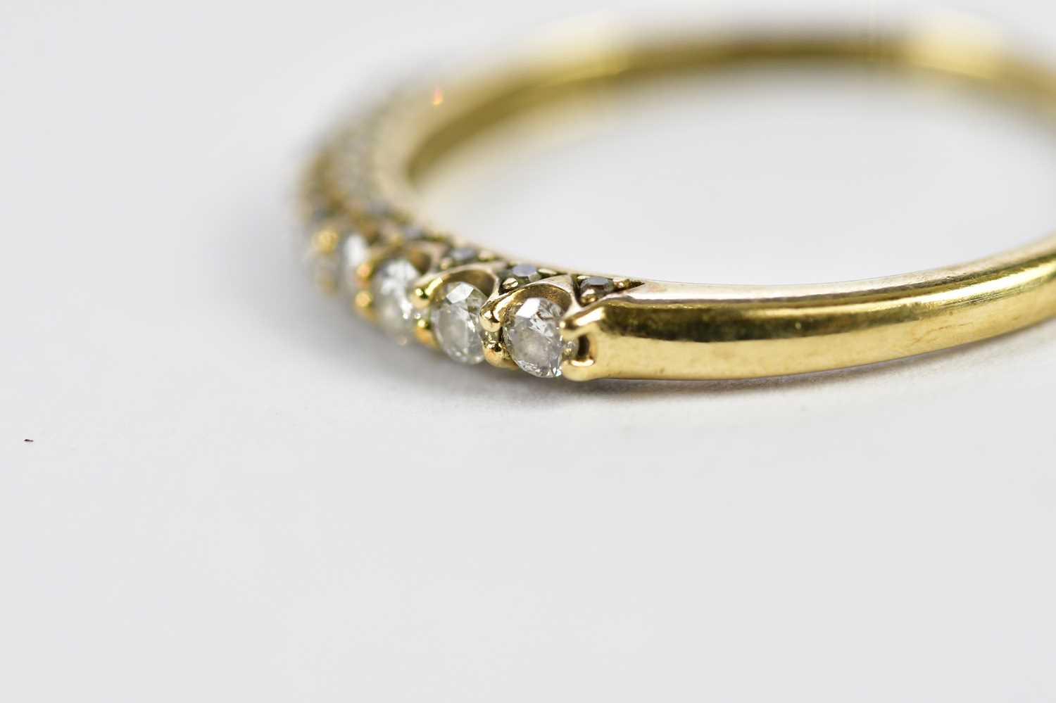 A 9ct yellow gold half eternity ring, set with nine principle stones and a melee of twnety stones, - Image 2 of 3