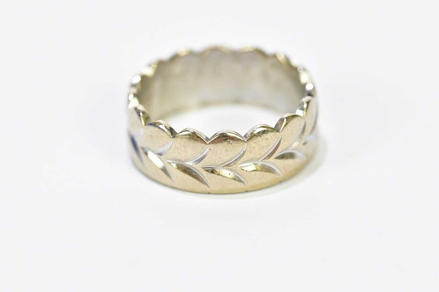 An 18ct white gold and yellow gold engraved wedding band, size L, approx. 7.36g.