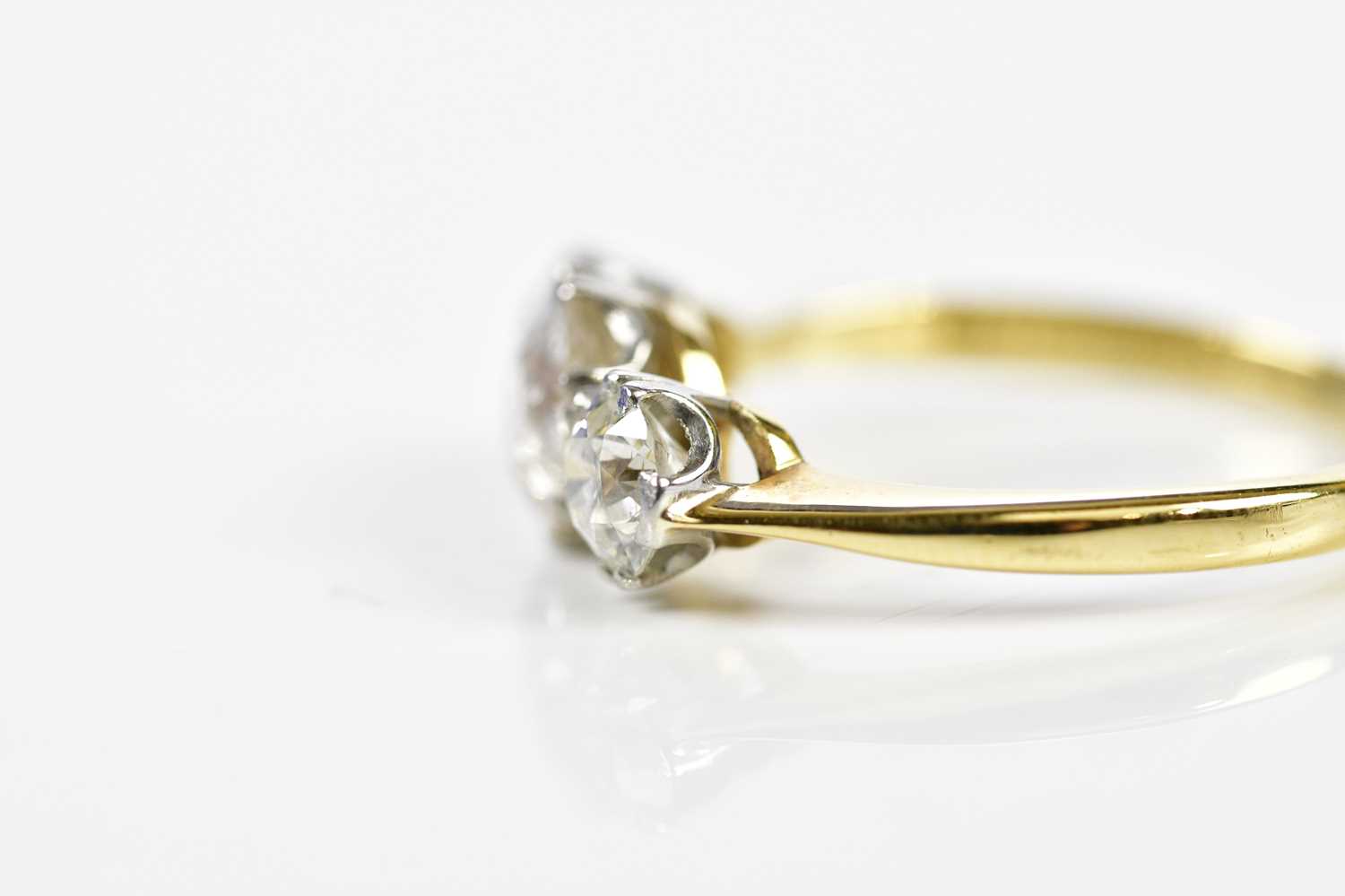 An 18ct yellow gold three stone diamond ring, the central old cut stone weighing approx. 1.20cts, - Image 2 of 3