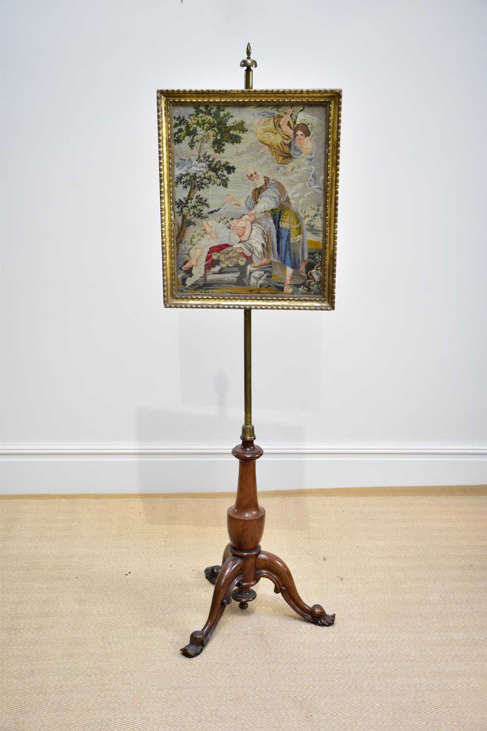 A Victorian pole screen with framed tapestry panel of a religious scene, on tripod base, height