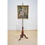 A Victorian pole screen with framed tapestry panel of a religious scene, on tripod base, height
