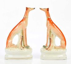 STAFFORDSHIRE; a pair of 19th century flatback figures of greyhounds, height 32cm. Condition Report: