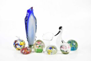 A collection of paperweights including a Murano scramble example, a faceted example with floral